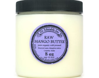 May include: A glass jar with a black lid containing raw mango butter. The label is purple and black with the text "Dr Adorable Inc. RAW MANGO BUTTER pure organic cold pressed Botanical name. Mangifera indica Country. India 100% natural 8 oz exp 12.202 www.dradorable.com".