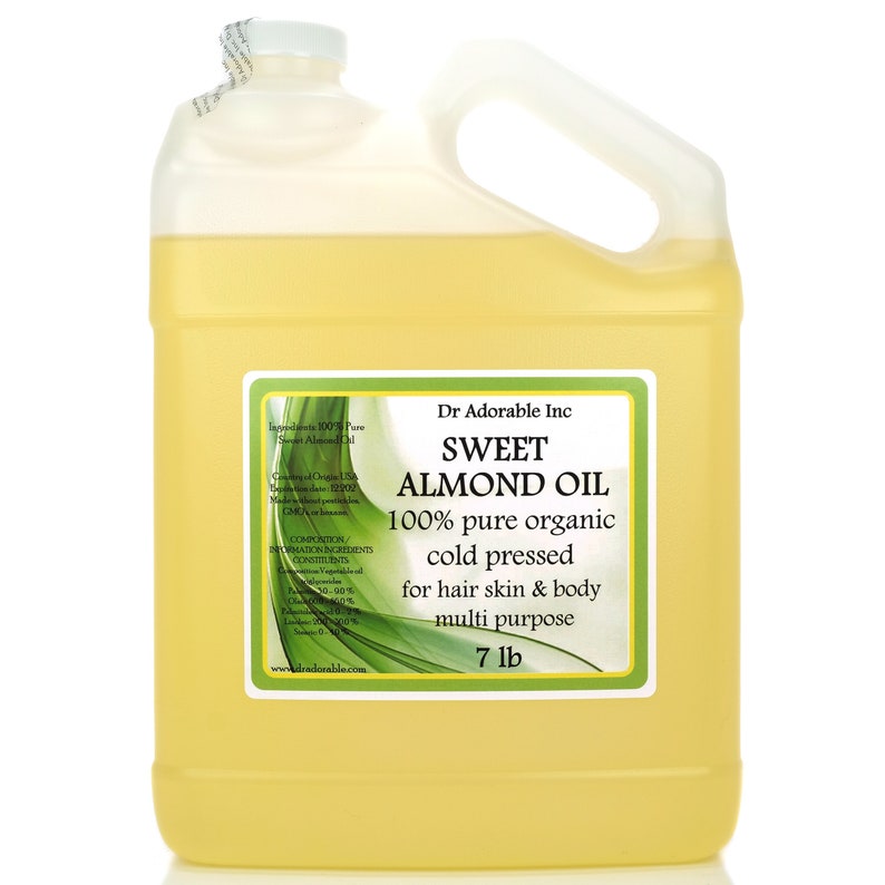 May include: A clear plastic gallon jug filled with yellow sweet almond oil. The label reads "Dr Adorable Inc. Sweet Almond Oil 100% pure organic cold pressed for hair skin & body multi purpose 7 lb."