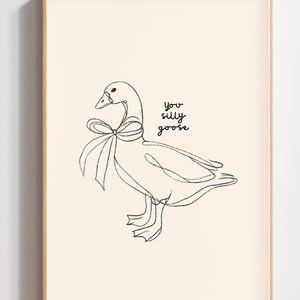 Minimalist line drawing of a goose wearing a bow, with playful handwritten text saying “you silly goose,” set on a soft cream background.