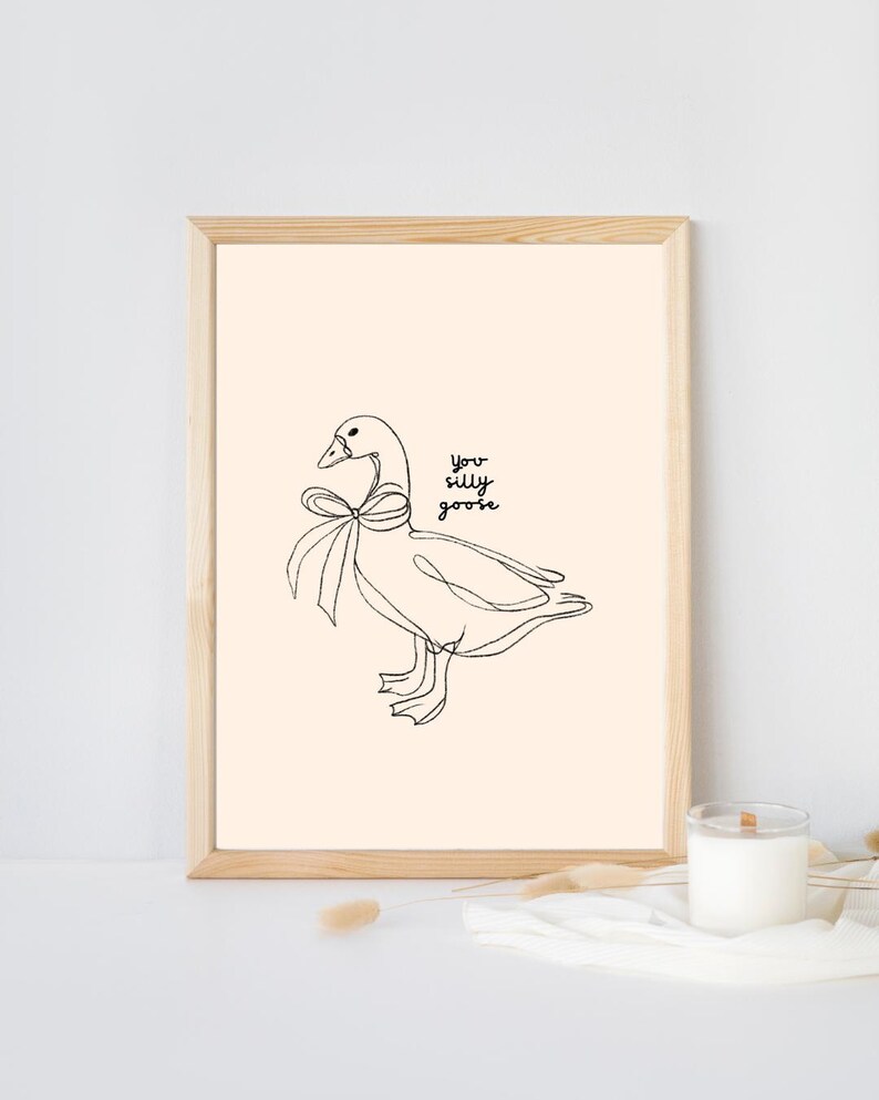Minimalist line drawing of a goose wearing a bow, with playful handwritten text saying “you silly goose,” set on a soft cream background.