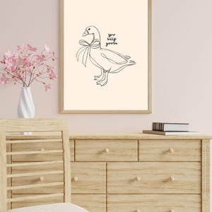 Minimalist line drawing of a goose wearing a bow, with playful handwritten text saying “you silly goose,” set on a soft cream background.