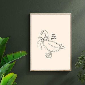 Minimalist line drawing of a goose wearing a bow, with playful handwritten text saying “you silly goose,” set on a soft cream background.