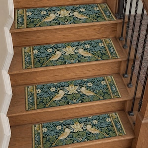 May include: Four rectangular stair treads featuring a dark teal and green botanical pattern with cream-colored birds and floral motifs. Each tread has a decorative border and is installed on wooden stairs with a black metal railing.