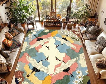 May include: A colorful area rug featuring a design of four white cranes with black accents, set against a backdrop of pastel colors and white flowers. The rug is a rectangular shape and is placed in a living room setting.