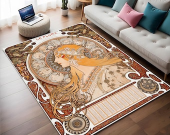 May include: A vintage-style rug with an intricate design featuring a woman with flowing hair and a floral crown. The rug has a cream background with gold, brown, and red accents. The text "La Plume" is visible in the upper left corner.