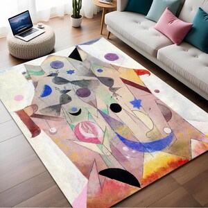 Könnte beinhalten: Abstrakter Kunstteppich mit geometrischen Formen und Farben, darunter Rosa, Blau, Gelb und Schwarz. Der Teppich hat einen weißen Hintergrund und ein modernes Design.