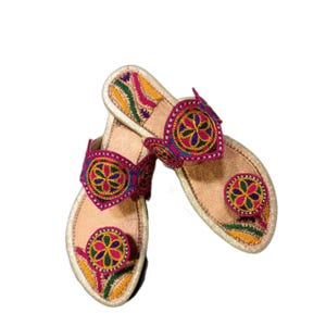 Könnte beinhalten: Ein Paar rosa und goldene bestickte Sandalen mit bunten Blumenmustern. Die Sandalen haben eine spitze Zehenpartie und eine flache Sohle.