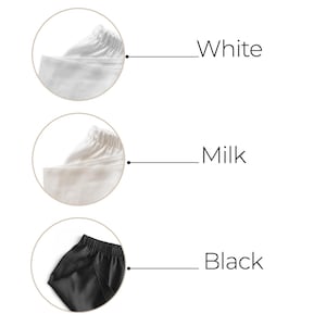 May include: Close-up of three fabric swatches showing different colours: white, milk, and black. The swatches are displayed in a circular frame.