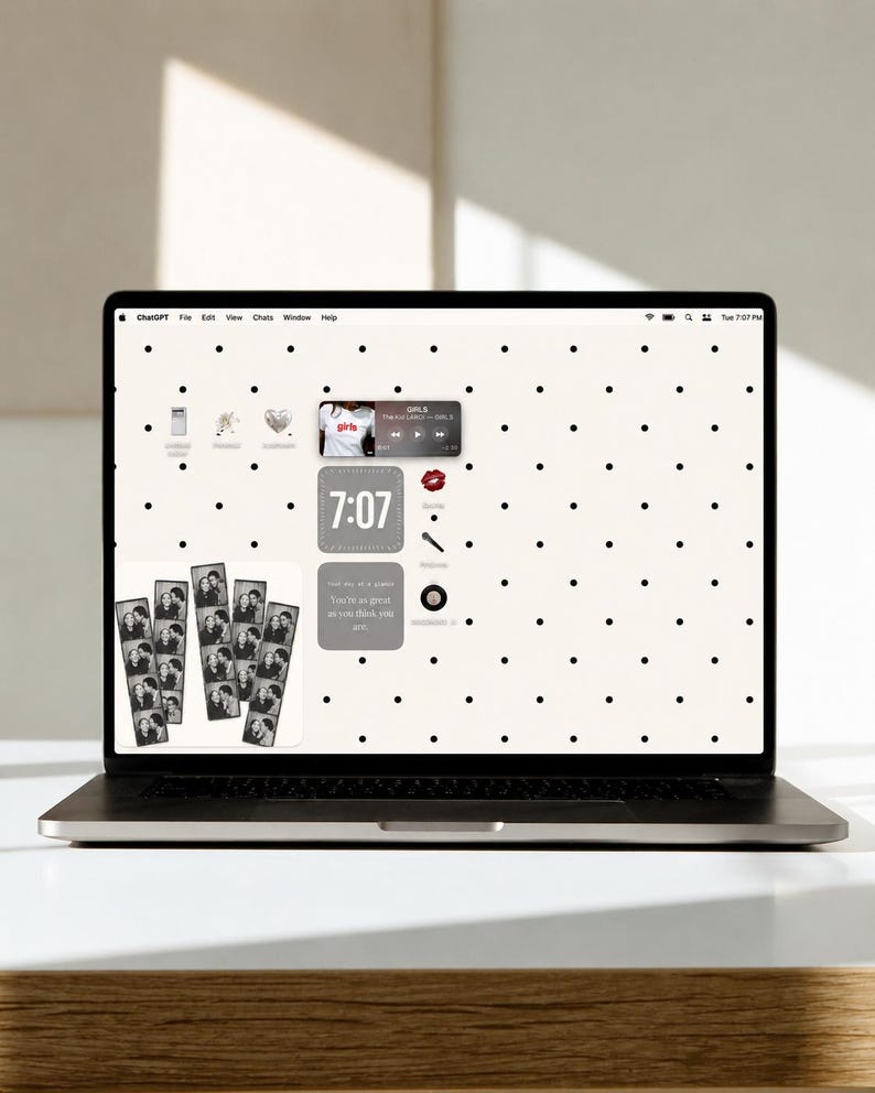May include: A laptop screen displaying a desktop interface with a white background featuring a black polka dot pattern. The screen shows various widgets, including a music player, a digital clock reading 7:07, and photo strips of people.