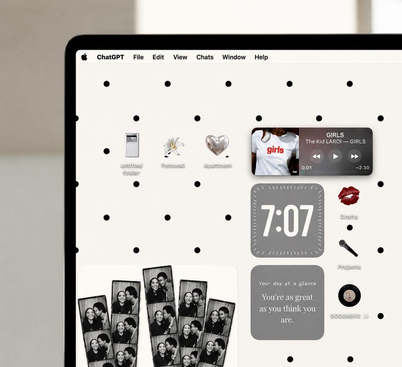 May include: A computer screen displaying a desktop interface with a white background featuring black polka dots. The screen shows various app icons, a music player widget playing The Kid LAROI, a digital clock widget, and photo strips.