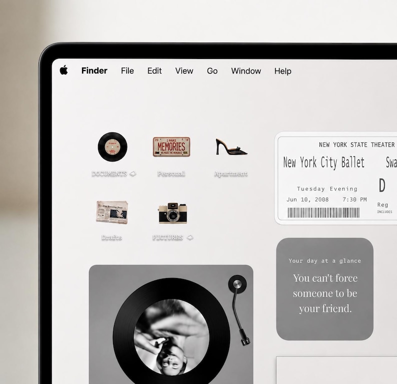 May include: A computer screen displaying a desktop interface with a top menu bar, various folder icons including a vinyl record, a license plate, a shoe, a newspaper, and a camera, plus a New York City Ballet ticket and a quote box.