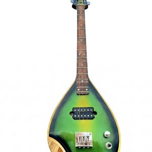 May include: A distinctive, teardrop-shaped stringed instrument with a wooden body and a long neck. The body has a green and yellow gradient, with a black border. The headstock is decorated with a carved wooden dragon. It has a bridge and two knobs.
