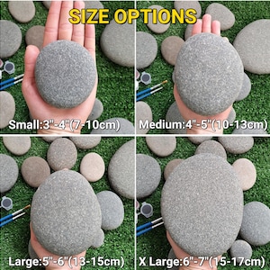May include: Image showing size options for gray river rocks. The sizes are small (7-10cm), medium (10-13cm), large (13-15cm), and X-large (15-17cm). The rocks are displayed on a green surface, with paintbrushes and paint palettes visible.