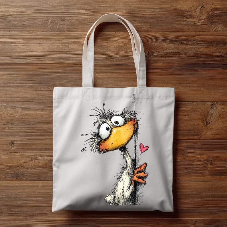 May include: White canvas tote bag featuring a whimsical cartoon duck with a large yellow beak, expressive eyes, and a red heart. The duck is drawn in a playful style, peeking from behind a line. The bag has two white handles.