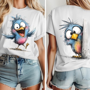 May include: White t-shirt featuring a cartoon bird illustration. The front shows a blue bird with pink accents, arms outstretched, and a wide open mouth. The back of the shirt displays a similar bird peeking from behind a wall.