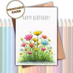Puede incluir: Una tarjeta de felicitación blanca con el texto HAPPY BIRTHDAY! en la parte superior y una colorida ilustración de flores silvestres en tonos rosa, amarillo y azul con tallos y hojas verdes. La tarjeta está frente a un sobre marrón.