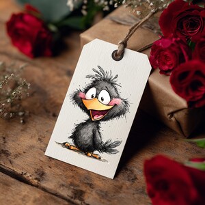 May include: A gift tag with a cartoon bird illustration. The bird is black with a yellow beak, pink cheeks, and big eyes. The tag is cream-colored with a brown string. Red roses and a wrapped gift are in the background.