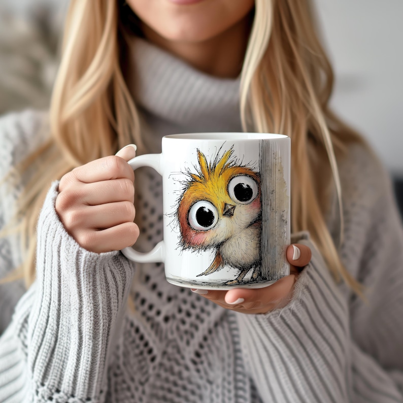 May include: White ceramic mug featuring a whimsical illustration of a cartoon owl with large, expressive eyes. The owl is depicted in shades of yellow, orange, and brown, peeking from behind a wooden post. The mug has a white handle.