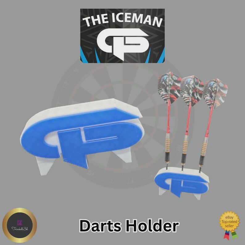 May include: A white and blue darts holder with the text "The Iceman" and "CP" logo. The holder is designed to hold three darts with red shafts and patterned flights. The words "Darts Holder" are also visible.