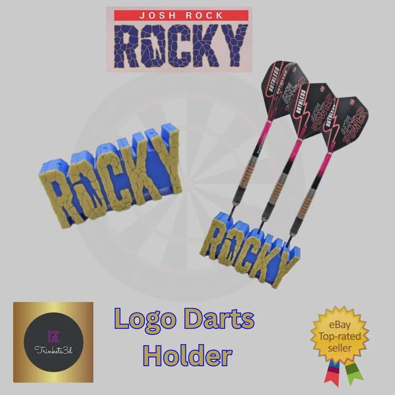 May include: A blue and gold "ROCKY" logo darts holder with three darts. The darts have pink and black flights. The image also includes a "JOSH ROCK" logo and the text "Logo Darts Holder".