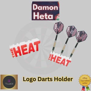 May include: A logo darts holder with the text "THE HEAT" in red and white. Three darts with black and red designs are displayed. The image also includes the text "Damon Heta".