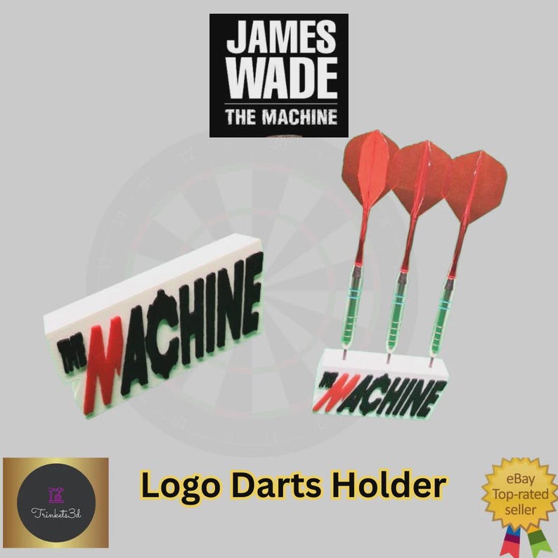 May include: A white and red logo darts holder with the text "MACHINE". Three red and green darts are displayed. The top of the image has the text "JAMES WADE THE MACHINE".