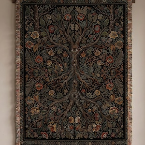 May include: A woven tapestry with a tree of life design, featuring intricate floral and foliage patterns in shades of brown, red, and green against a black background. The tapestry has a fringed edge and is mounted on a wooden rod.