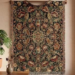May include: A tapestry with a floral pattern in shades of brown, red, and green against a black background. The tapestry is rectangular with a fringed edge and is mounted on a wooden rod. The design features stylized flowers and leaves.