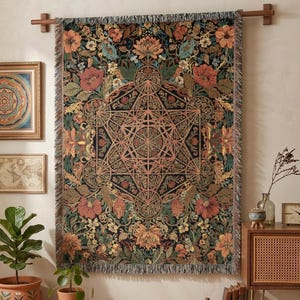 May include: A rectangular woven tapestry featuring a central geometric Metatron's cube design surrounded by a dense floral pattern in shades of orange, red, green, and gold on a black background, finished with a fringed edge on all sides.