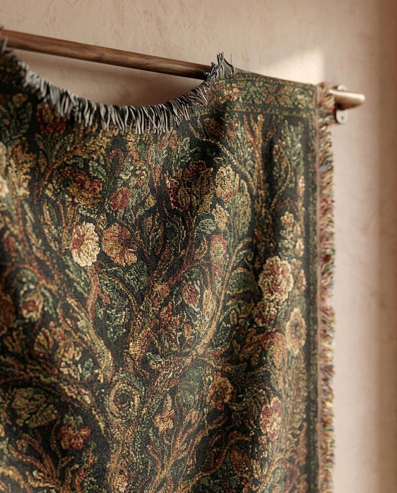 May include: A dark green tapestry with a floral pattern in shades of brown, gold, and red. The tapestry is hanging on a wooden rod and has a fringed edge. The design features stylized flowers and foliage.