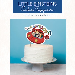 May include: A red rocket cake topper with the words "Happy Birthday!" and four cartoon characters from the show "Little Einsteins".