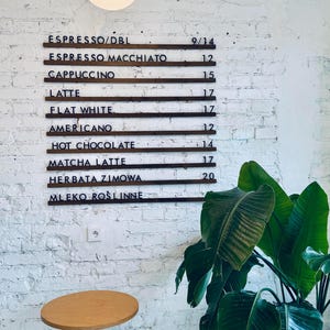 Close-up of changeable letter board with wooden rails and black letters