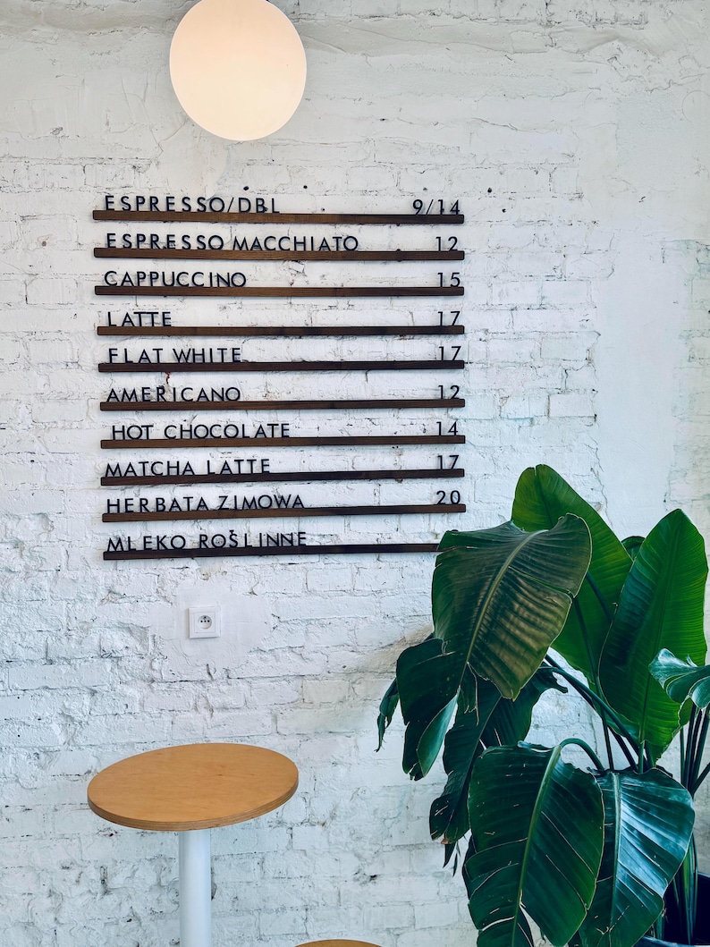Close-up of changeable letter board with wooden rails and black letters