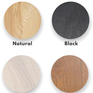 May include: Four wood samples showing different colors: natural, black, white, and brown. The wood samples are circular and have a wood grain pattern.