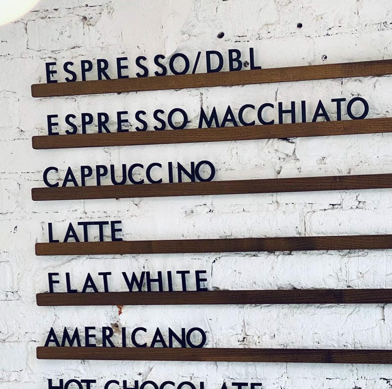 Side view of wall-mounted wooden menu rails with customizable letters.
