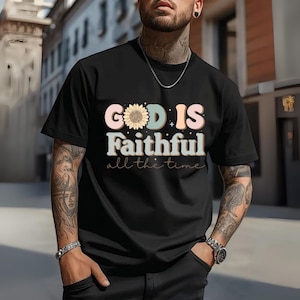 May include: Black t-shirt with the text "GOD IS Faithful all the time" in a colorful, retro font. The word "GOD" features a sunflower design. The shirt is short-sleeved and has a crew neck.
