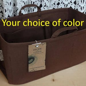 May include: A brown felt organizer with handles and multiple compartments. The text "Your choice of color" is displayed across the top. A tag reads "DIVIDE AND CONQUER".