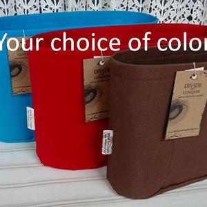 May include: Three fabric storage containers in different colors: turquoise, red, and brown. Each container has a tag attached that says "Divide and Conquer".