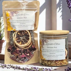 May include: A brown paper pouch and a clear glass jar with a bamboo lid, both labeled Lavender Citrus Simmer Pot by Ramos Co. The containers hold dried lavender, rose petals, and dehydrated orange slices. The labels list ingredients and instructions.