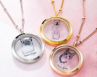 May include: Three round pendant necklaces with pet portraits inside. One is silver with a cat portrait and the name "Brown Sugar". The second is gold with a dog portrait and the name "Ulrica". The third is rose gold with a cat portrait and the name "Shine Kitty".