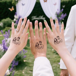 May include: Three hands displaying temporary tattoos of a couple, each with the names "Emma & Liam" and a date. The tattoos are in black ink. The background features a wedding arch and floral arrangements.
