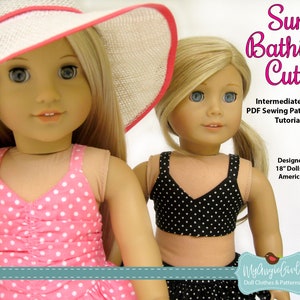 May include: Two dolls wearing swimwear. One doll is in a pink polka dot swimsuit and a white sun hat with a pink trim. The other doll is in a black polka dot bikini. Text on the image reads "Sun Bathing Cutie" and "Designed to Fit 18" Dolls such as American Girl".