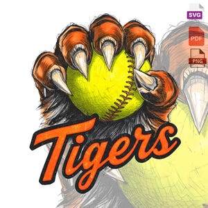 May include: A graphic design featuring a tiger claw gripping a yellow softball. The claw is orange and brown, with sharp white claws. The word "Tigers" is written in orange, outlined in black, below the claw and ball.