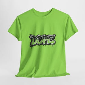 May include: A lime green t-shirt with the word "DOPE" in a black and white graffiti style design. The word has a dripping effect, adding a street art aesthetic to the shirt.