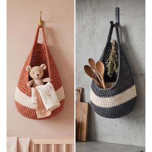 May include: Two hanging crochet storage baskets. One is rust-colored with a cream stripe, holding a teddy bear and a folded cloth. The other is gray with a cream stripe, holding wooden spoons and dried herbs. Both are suspended from hooks.
