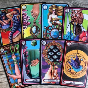 May include: A set of ten tarot cards with colorful illustrations. The cards feature a variety of imagery, including a woman with a crown, a bird in a cage, and a hand holding a mirror. The cards are numbered IX through XX and include the names "The World", "Judgement", and "The Sun".