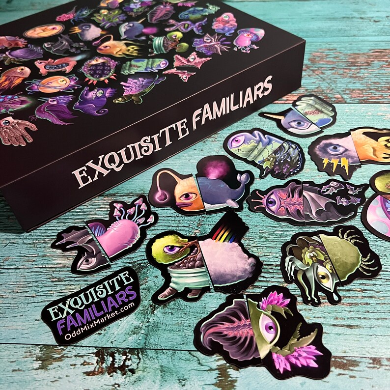 Puede incluir: Un conjunto de pegatinas con criaturas caprichosas y coloridas con detalles intrincados. Las pegatinas est&aacute;n dispuestas sobre una superficie de madera con una caja negra que dice "EXQUISITE FAMILIARS" y "OddMixMarket.com".