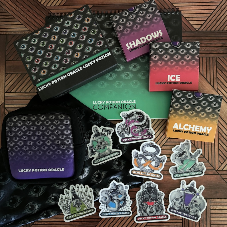May include: A set of Lucky Potion Oracle cards and companion guidebook with a black and green eye pattern. The set includes cards for Shadows, Ice, and Alchemy. There are also several stickers with different designs, including a snake, a skull, and a mushroom.