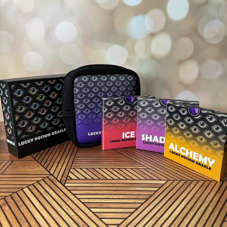 May include: Four decks of playing cards with a black and white eye pattern. The decks are labeled "Ice", "Shady", "Alchemy", and "Lucky Potion Oracle".