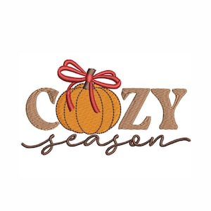 May include: An embroidered design featuring a pumpkin with a red bow, the word "COZY" in brown block letters, and the word "season" in a brown cursive font. The design is on a white background.